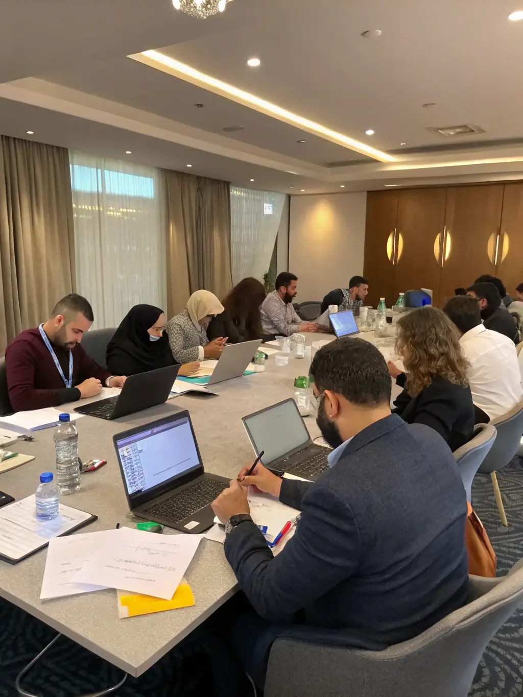 A diverse group of individuals participating in a training session, symbolizing the skills development and empowerment provided by En Route Vers L'Avenir.